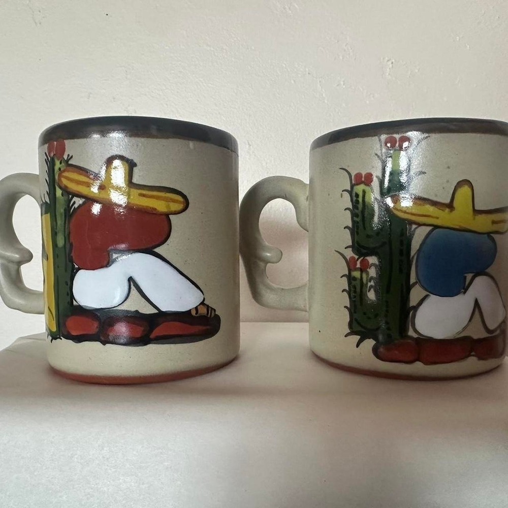 Vintage Handmade ceramic coffee mugs with colorful cactus designs and a sleep.